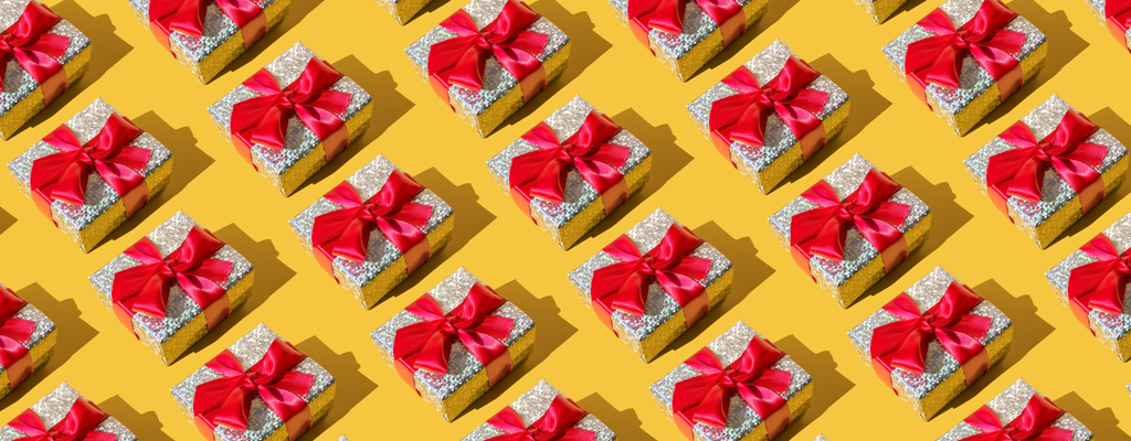 silver-wrapped gift boxes tied with a bright red bow