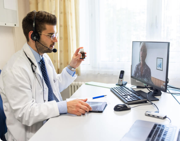 Doctor sitting at a desk with a computer