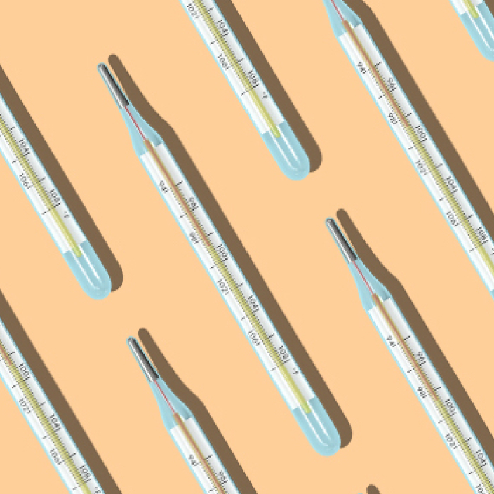 thermometers resting on a light peach colored background