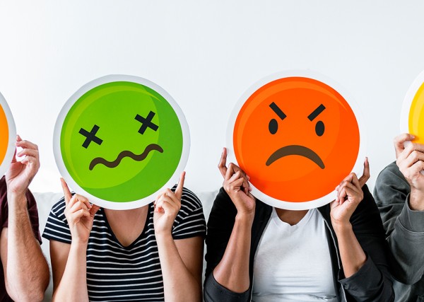 people hold up images of a shocked, nauseated, angry, and frustrated face in front of their own