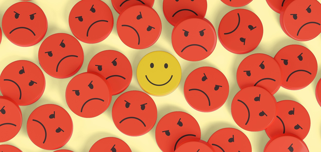 One happy face among a see of red, angry faces